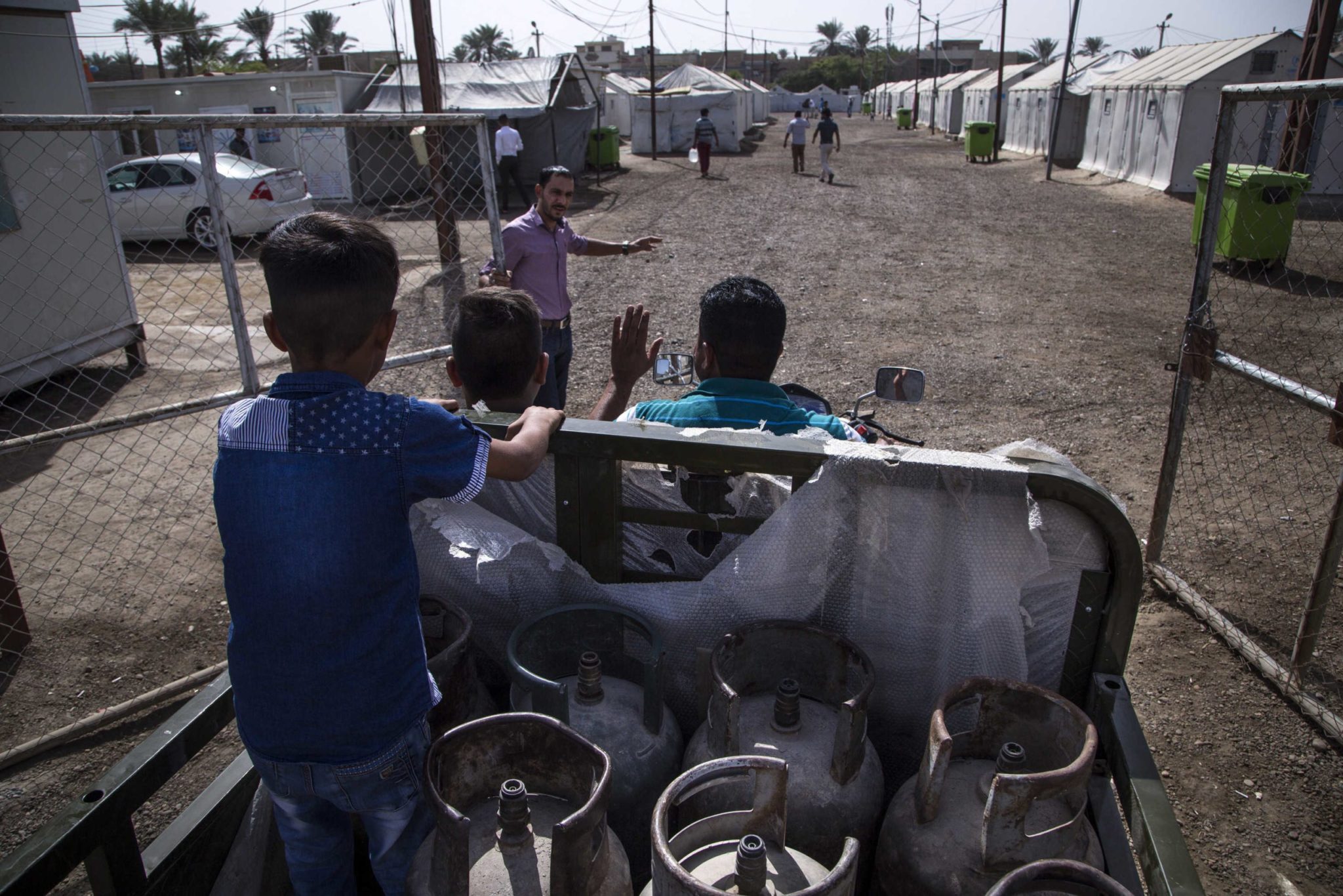 Iraq. Selling gas canisters in Al-Khadra camp near Baghdad